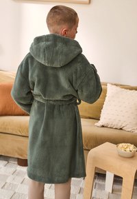 Green fleece bathrobe with a hood, featuring a textured, soft exterior, tied waist belt, and knee-length cut, seen from the back.