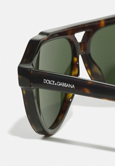 Tortoise-shell prillid roheliste läätsede jaotusega. Omavad julgeid, nurgelisi raamistikku. Tempel on graveeritud logo „DOLCE & GABBANA“. Sile pind.