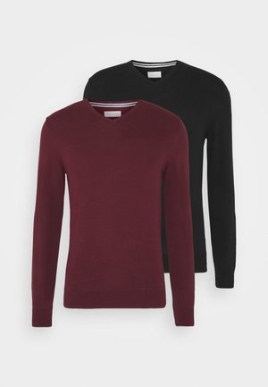 Two v-neck sweaters in burgundy and black. Both have long sleeves and ribbed cuffs, made from a soft knit material. Striped neckline detail.