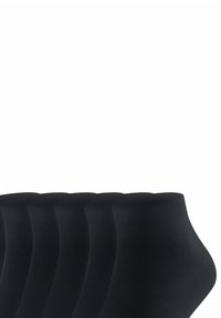 Svarta ankelsockor med ribbad textur och elastiska muddar, visade i ett staplat läge mot en enkel bakgrund.
