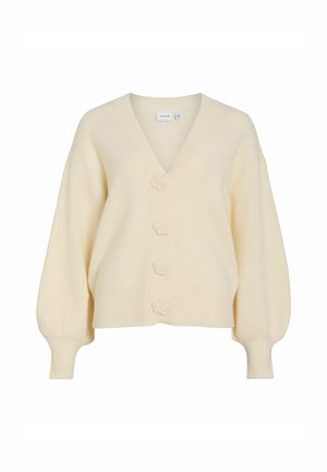 Cardigan crème avec un décolleté en V profond, des manches oversized et cinq boutons floraux. Tissu en maille douce avec des poignets et un ourlet côtelés.