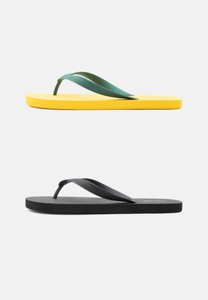 Rumena japonka z zelenimi trakovi in črna japonka s črnimi trakovi, stranski pogled na belem ozadju.