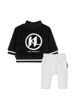 Haut noir à manches longues pour tout-petit avec logo blanc Karl Lagerfeld et pantalon matelassé blanc avec taille élastique.