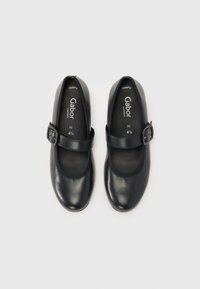 Black leather Mary Jane shoes with a round toe, ankle strap featuring a buckle, cushioned insole, and smooth finish. Size H 4½.