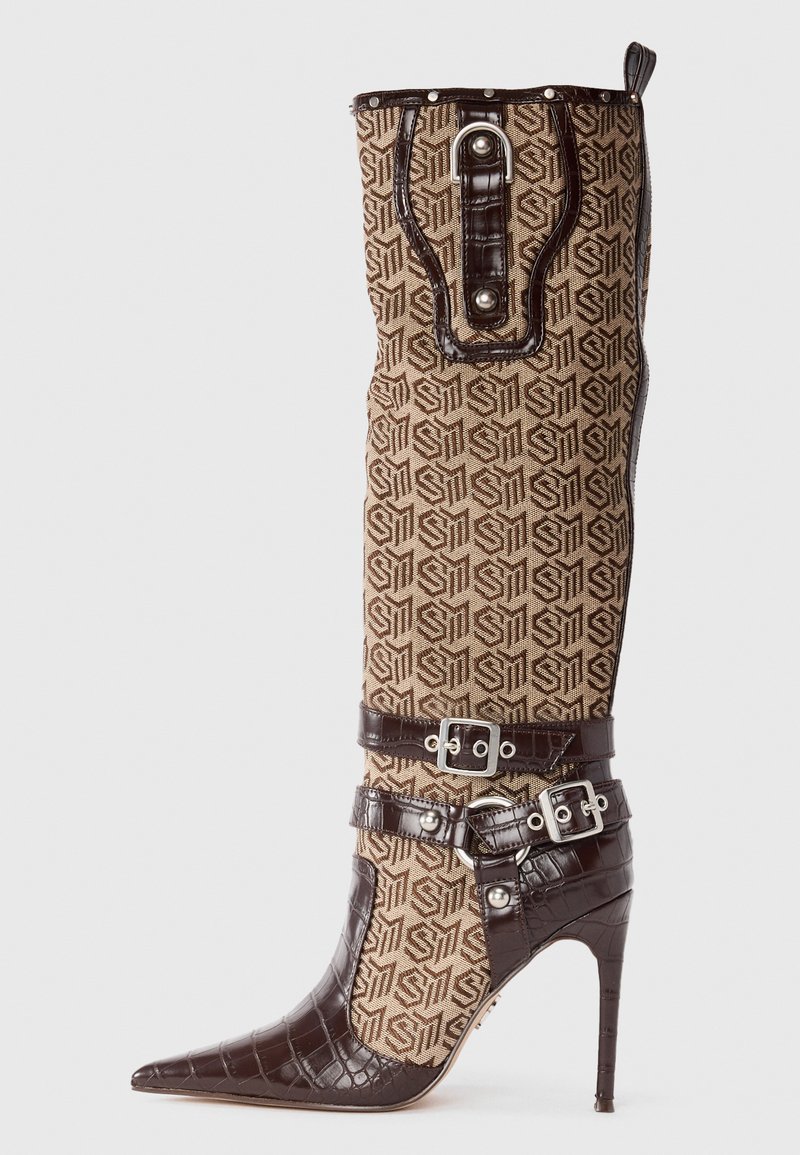 High-heeled boot featuring a patterned brown fabric upper with a shiny brown crocodile-textured leather accent, adjustable straps, and pointed toe.