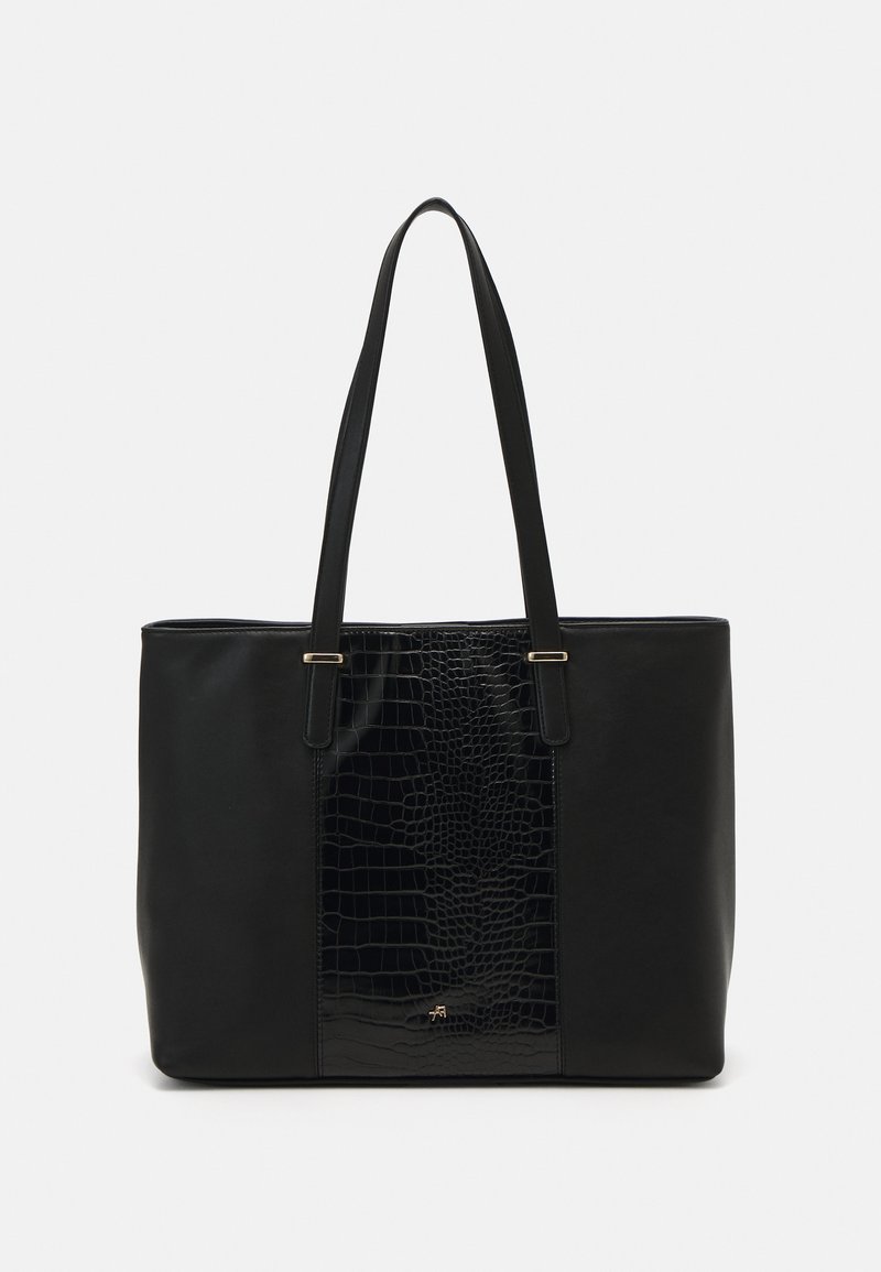 Sac fourre-tout noir en cuir lisse, présentant un motif crocodile texturé et brillant au centre. Deux poignées et accents dorés.