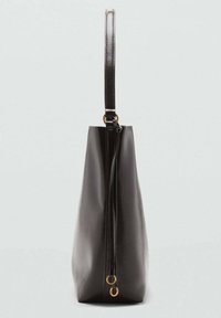 Tall black leather tote bag with a single shoulder strap and gold metal rings on the side against a plain light background.
