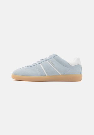 Light blue suede sneaker with white leather accents, featuring three white stripes, round toe, and a gum rubber sole.
