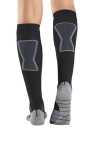 Knielange Kompressionssocken in Schwarz mit grauen Akzenten. Rippendesign am Bein und gestreiftes Muster an der Fußsohle, mit verstärkter Ferse und Zehen.