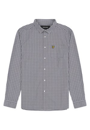 Camicia a quadri bianca e nera con colletto button-down e maniche lunghe. Presenta un piccolo logo giallo sulla tasca del petto.