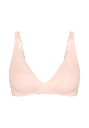 Světle béžová bezdrátová podprsenka s nastavitelnými ramínky a hladkými, tvarovanými košíčky, navržená pro pohodlí a každodenní nošení.