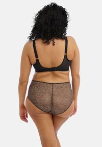 Schwarzer BH mit verstellbaren Trägern, kombiniert mit hochgeschnittenen, durchsichtigen Leopardenmuster-Panties. Glatte Textur mit kontrastierenden schwarzen Akzenten.