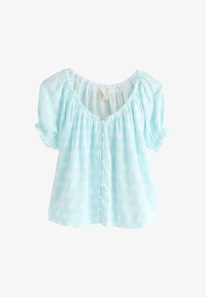 Light blue short-sleeve blouse with white polka dots, round neckline, ruffled sleeves, and a front row of fabric-covered buttons.