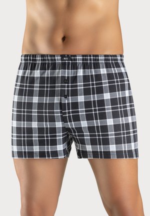 Black and white plaid boxer shorts with an elastic waistband, two front buttons, and a soft cotton texture.