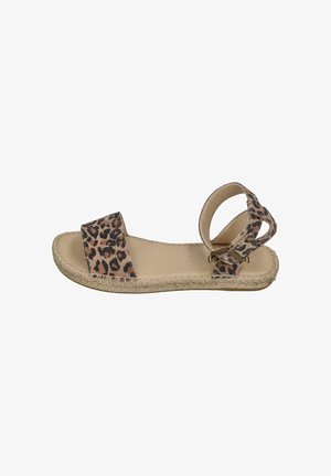 Flat sandal with leopard print fabric straps, open toe, ankle buckle, and woven sole detail on a beige footbed.