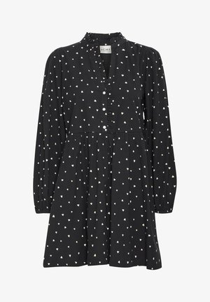 Schwarzes Kleid mit langen Ärmeln, kleinem weißen Herzmuster, gerafftem Knopfleisten und einem ausgestellten Rock. Hergestellt aus leichtem Stoff.