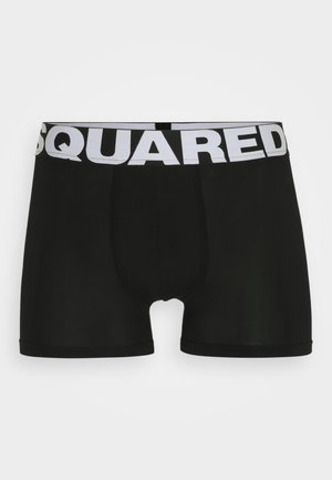 Boxer-briefs noirs en tissu extensible, dotés d'une large ceinture élastique blanche avec le logo "SQUARED", conçus pour un ajustement près du corps.