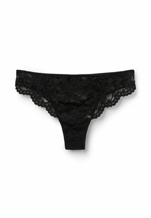 Tanga de encaje negro con patrón floral, bordes en forma de ondas y una textura transparente, que presenta una cobertura mínima y un diseño clásico.