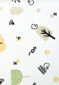 Stof met een witte achtergrond en kleurrijke illustraties van vogels, bomen, bladeren en kleine bloemen in groen, geel en zwart.