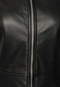 Black leather jacket featuring a smooth texture, front zipper closure, and subtle stitching details along the seams.