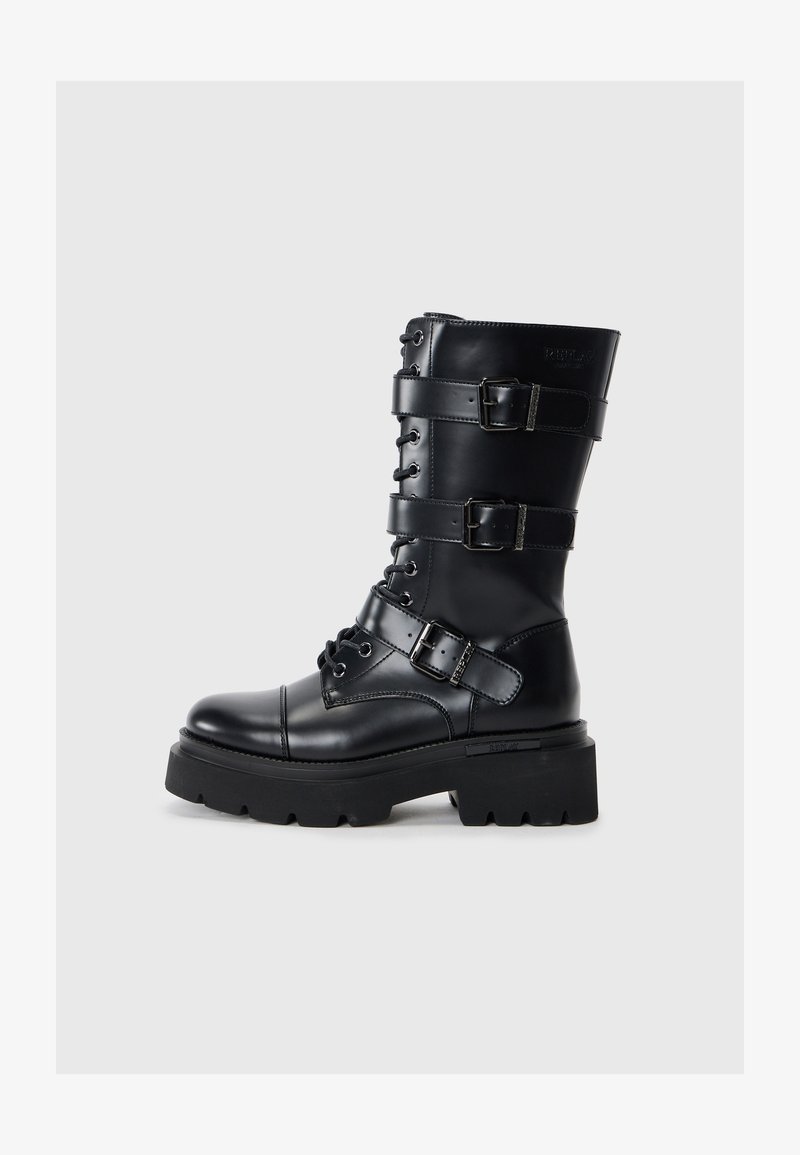 Black leather knee-high boot featuring lace-up front, multiple adjustable straps, thick platform sole, and rounded toe.