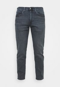 Mörkgrå denimjeans med slim fit, som har en traditionell fem fickors design, dragkedja och synliga sömnadsdetaljer.