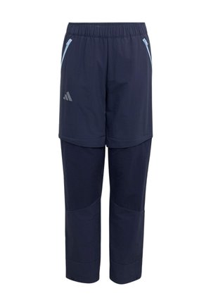 Mørkeblå konvertible bukser med elastisk talje, lynlåslommer på siden og Adidas-logo på lårets øverste del.