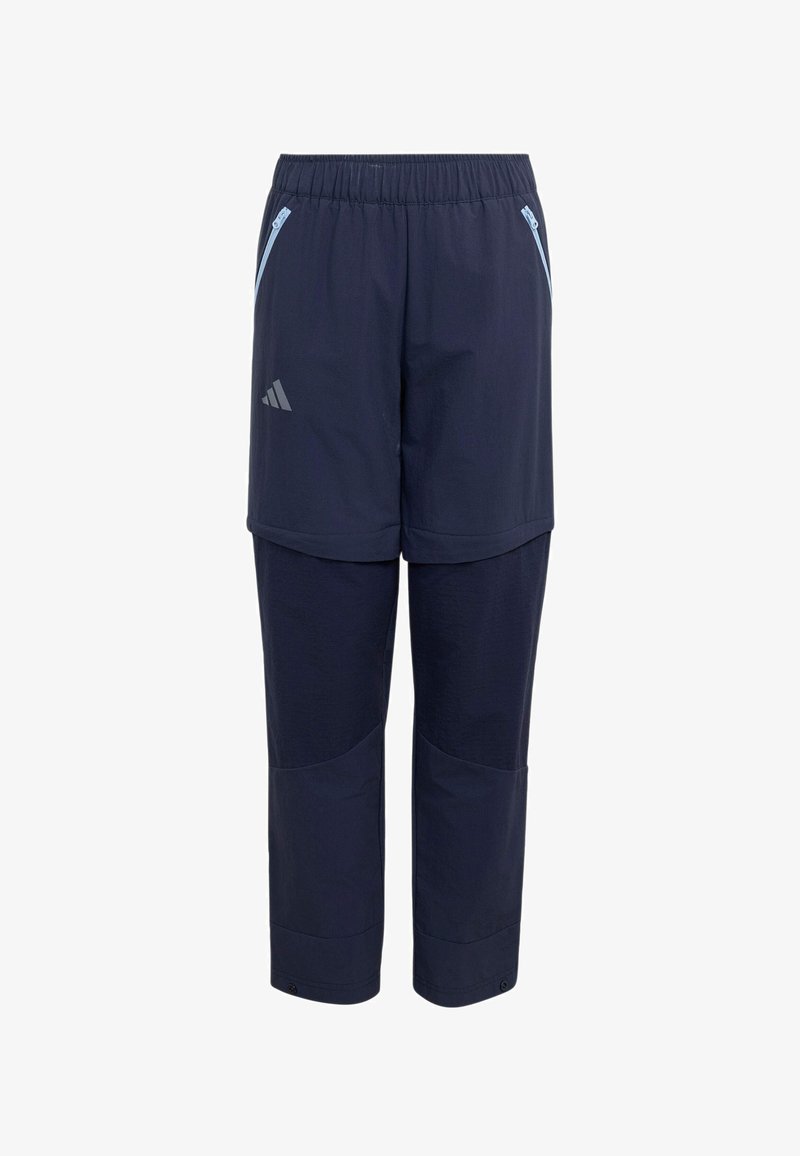 Pantalon convertible bleu marine avec taille élastique, poches latérales zippées et logo Adidas sur le haut de la cuisse.