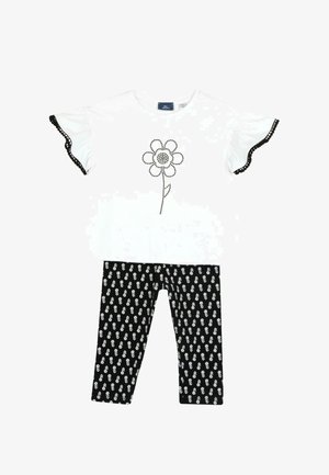 Haut court à manches courtes blanc avec des bordures noires et un motif floral, associé à un legging noir à motif floral blanc.