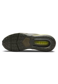 Nike-sneakersula med en texturerad svart gummiyta, med en synlig luftkuddsenhet i starkt gult och ett geometriskt mönster.