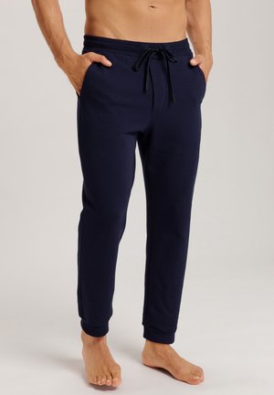 Marineblaue Jogginghosen aus weichem Stoff, mit seitlichen Taschen, einem elastischen Taillenbund mit Kordelzug und eng anliegenden Bündchen an den Knöcheln.