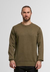 Pullover verde oliva realizzato in tessuto a maglia strutturata. Caratterizzato da un colletto rotondo, polsini a costine e un orlo dritto.