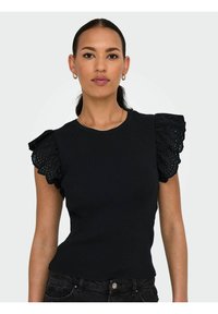 Sort ribbetop med blondeflæser, der har en tætsiddende pasform og rund halsudskæring. Den teksturerede stof tilføjer visuelt interesse.
