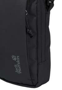 Sac bandoulière Black Jack Wolfskin avec poche zippée à l'avant, logo de la marque et sangle ajustable.