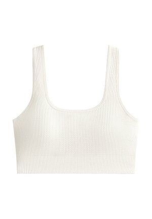 Witte geribbelde bralette met een vierkante halslijn en dikke schouderbanden. De stof heeft een gestructureerd oppervlak met een aansluitend ontwerp.