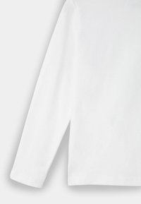 Long-sleeve white shirt made of smooth cotton, featuring a simple design with a slight side split at the hem.