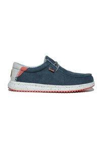 Blue canvas slip-on shoes with a speckled white and red sole, featuring a round toe, lace loop detail, and a patterned accent at the heel.