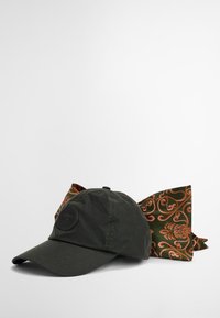 Dark green cap with a rounded crown, featuring a patch logo. Accompanied by a patterned olive scarf with orange floral designs.