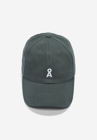 Dark green baseball cap with a white embroidered logo, six-panel design, adjustable strap, and ventilation eyelets on top.