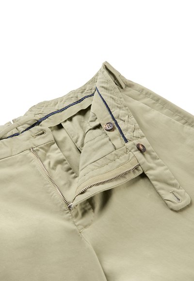 Khaki pants with open zipper and button closure, showing inner waistband with a dark blue trim detail.