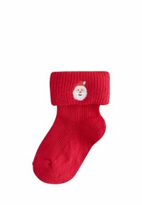 Rote Stricksocke mit geripptem Muster und umgeschlagenem oberen Teil, mit einem gestickten Weihnachtsmann-Gesicht auf der Vorderseite. Klassisches Design für festliche Anlässe.