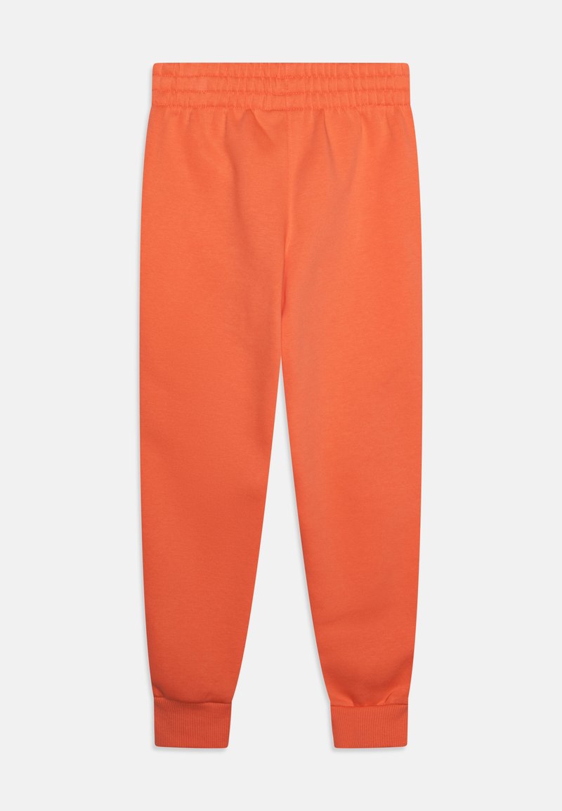 Pantaloni della tuta in cotone arancione con vita elasticizzata e polsini aderenti. Texture liscia, design a gamba dritta, senza motivi o accessori visibili.