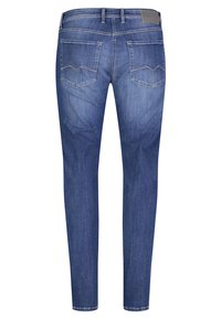 Slim-fit blue denim jeans with a smooth texture, featuring two back pockets with zigzag stitching and a leather brand patch on the waistband.