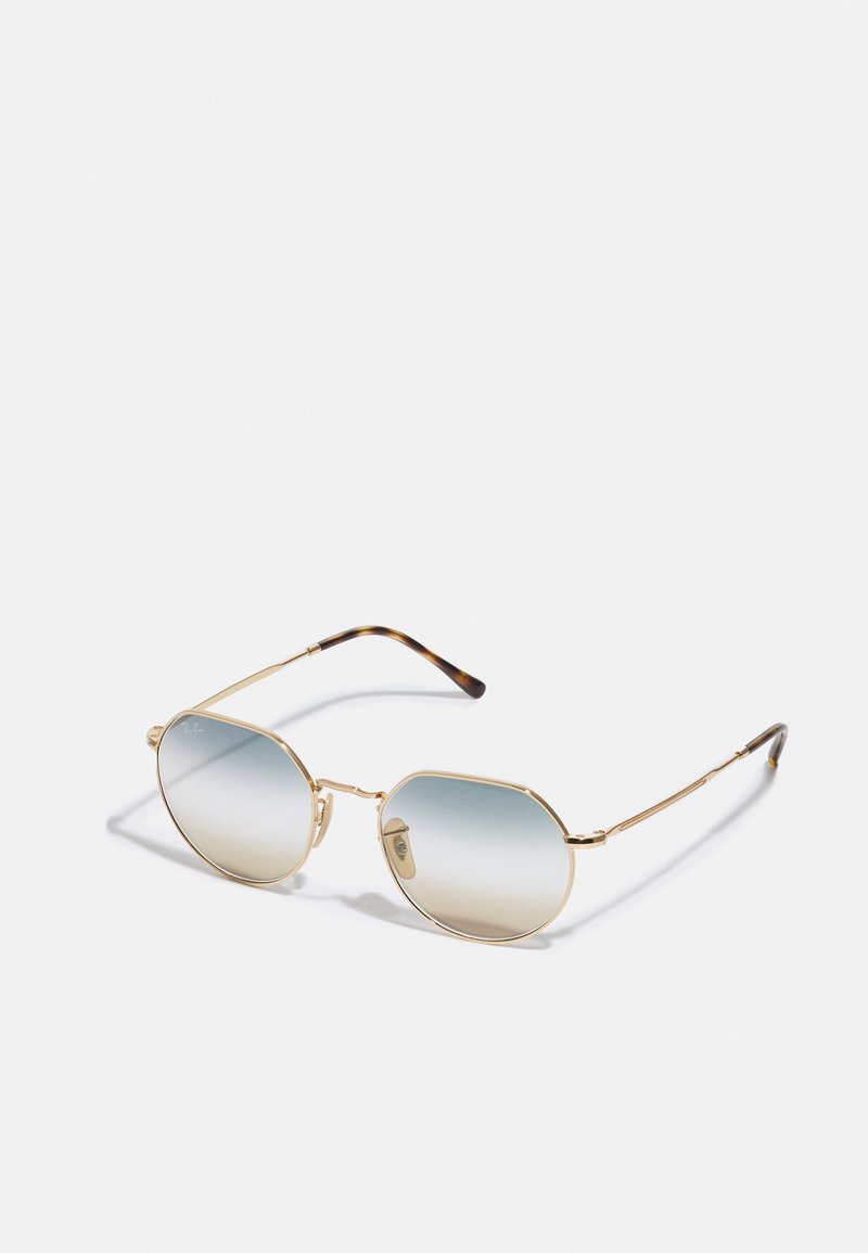 Occhiali da sole in metallo dorato con forma ottagonale, lenti blu sfumate e aste con motivo tartarugato. Design minimalista e costruzione leggera.