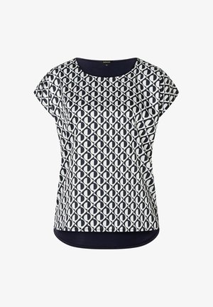 Blouse à manches courtes à motifs bleu marine et blanc, avec un col rond et un ourlet arrondi, présentant des formes ovales répétées sur une surface textile.