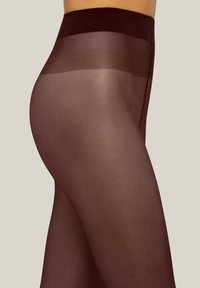 Collant opaco marrone con vita alta. Il materiale appare liscio con una leggera lucentezza e un colore uniforme in tutto il capo.