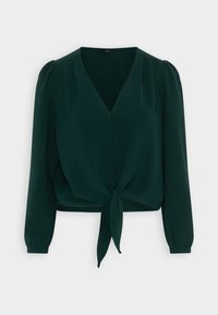Green cropped blouse made of textured fabric. Features a V-neck, button front, long sleeves, and a tied knot at the bottom.