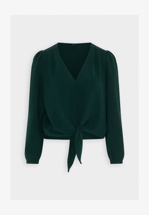 Grønn avkortet bluse laget av teksturert stoff. Har V-hals, knappelukking, lange ermer og en knyttet knute nederst.
