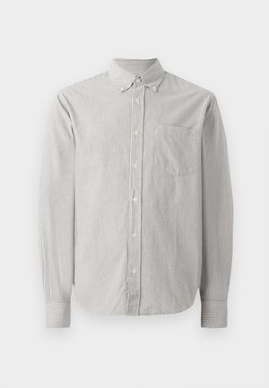 Prugasta košulja dugih rukava od pamuka. Ima ovratnik s gumbima, jednu mrežicu na prsima i manžete s prugastim detaljima.