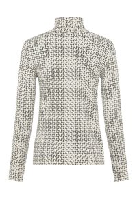 Langærmet turtleneck i cremefarvet stof med et geometrisk mønster i sort. Glat tekstur med en tætsiddende silhuet og høj krave.